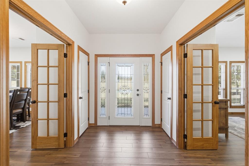 160 Falcon Drive Weatherford, TX 76088 - Photo 4 of 40 a view of a livingroom with wooden floor and windows
