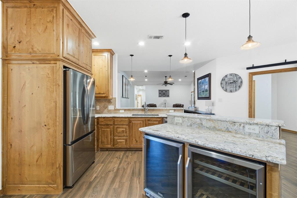 160 Falcon Drive Weatherford, TX 76088 - Photo 9 of 40 a kitchen with stainless steel appliances granite countertop a sink and refrigerator