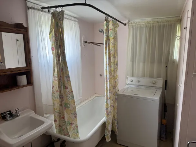 a bathroom with a toilet a sink and a mirror