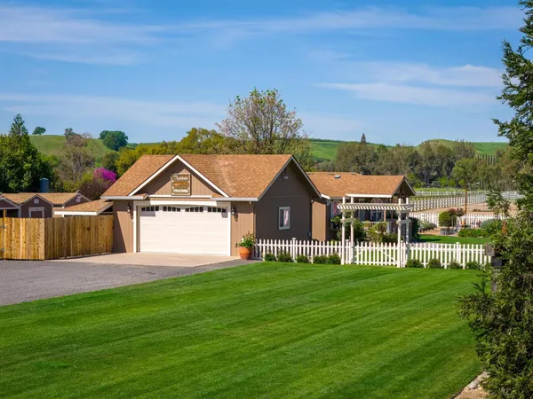 a bathroom with a granite countertop sink mirror vanity and toilet