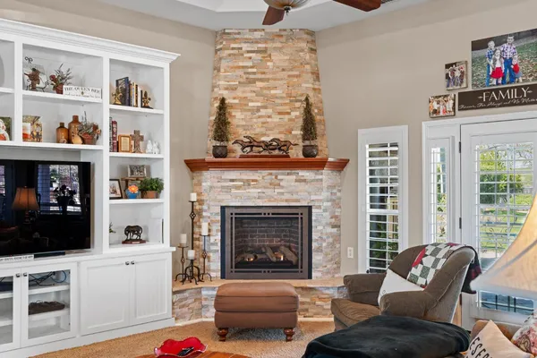 a bathroom with a granite countertop tub sink and mirror