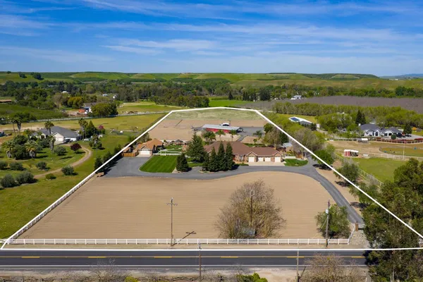 an aerial view of a house with outdoor space and lake view