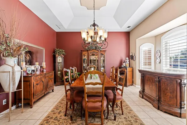 a view of a fountain with table and chairs next to a yard
