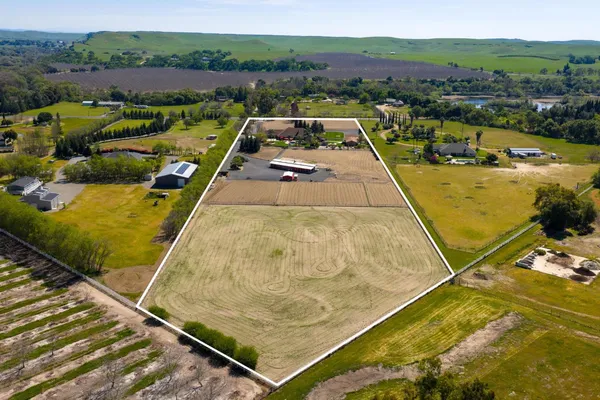 a view of a table and chairs in a backyard