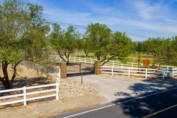 a view of an house with swimming pool garden and patio