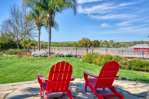 a view of a patio with table and chairs under an umbrella