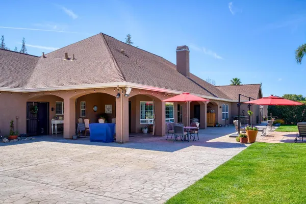 a bathroom with a granite countertop sink mirror and toilet