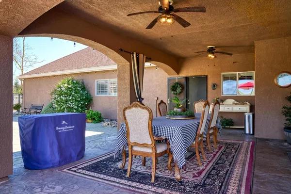 an aerial view of a house with a swimming pool and outdoor seating