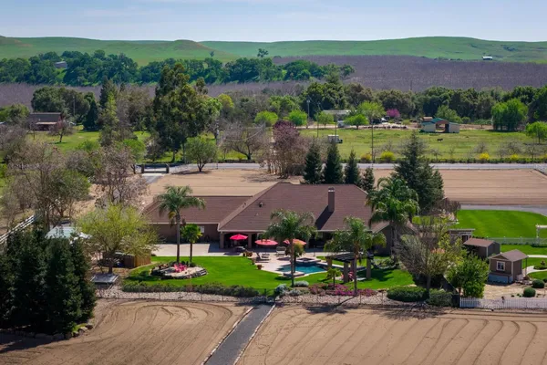 an aerial view of a residential houses with outdoor space and street view