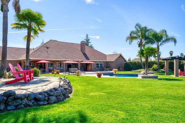 a living room with furniture a fireplace and a chandelier