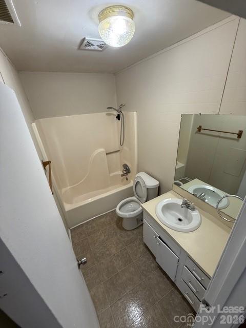 a bathroom with a granite countertop sink a toilet and a mirror