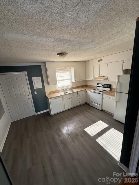 607 Legion Road Lenoir, NC 28645 - Photo 4 of 6 a kitchen with granite countertop a sink stove and refrigerator