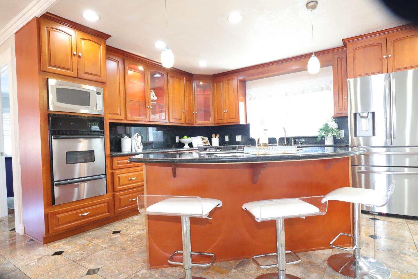 5450 Monterey Road, Unit 168 San Jose, CA 95111 - Photo 24 of 65 a kitchen with stainless steel appliances kitchen island granite countertop dining table chairs cabinets and a large window