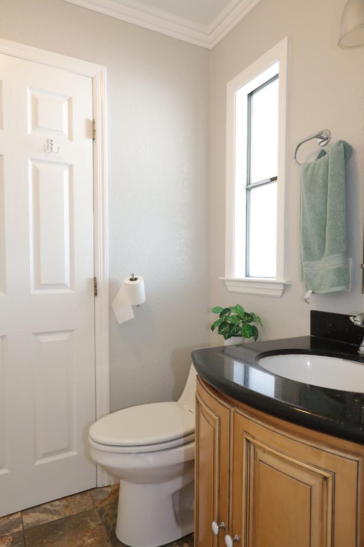 5450 Monterey Road, Unit 168 San Jose, CA 95111 - Photo 49 of 65 a bathroom with a granite countertop sink a toilet and a mirror