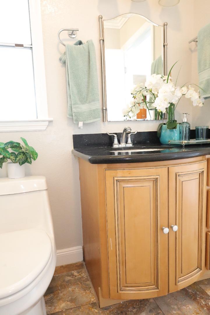 5450 Monterey Road, Unit 168 San Jose, CA 95111 - Photo 52 of 65 a bathroom with a granite countertop sink and a mirror