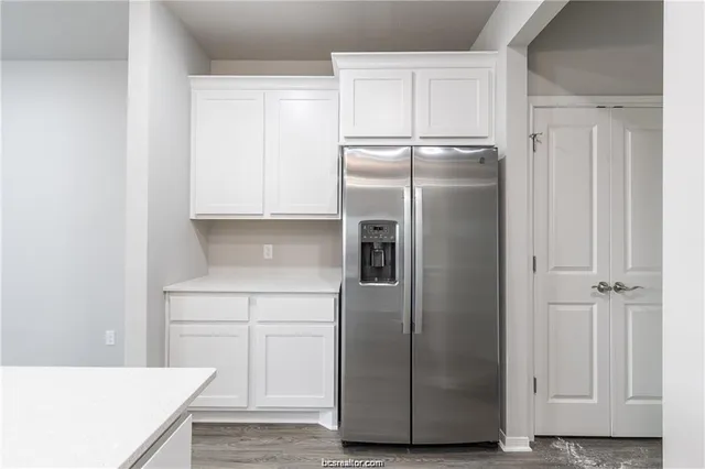 a kitchen with metallic refrigerator freezer and a dishwasher