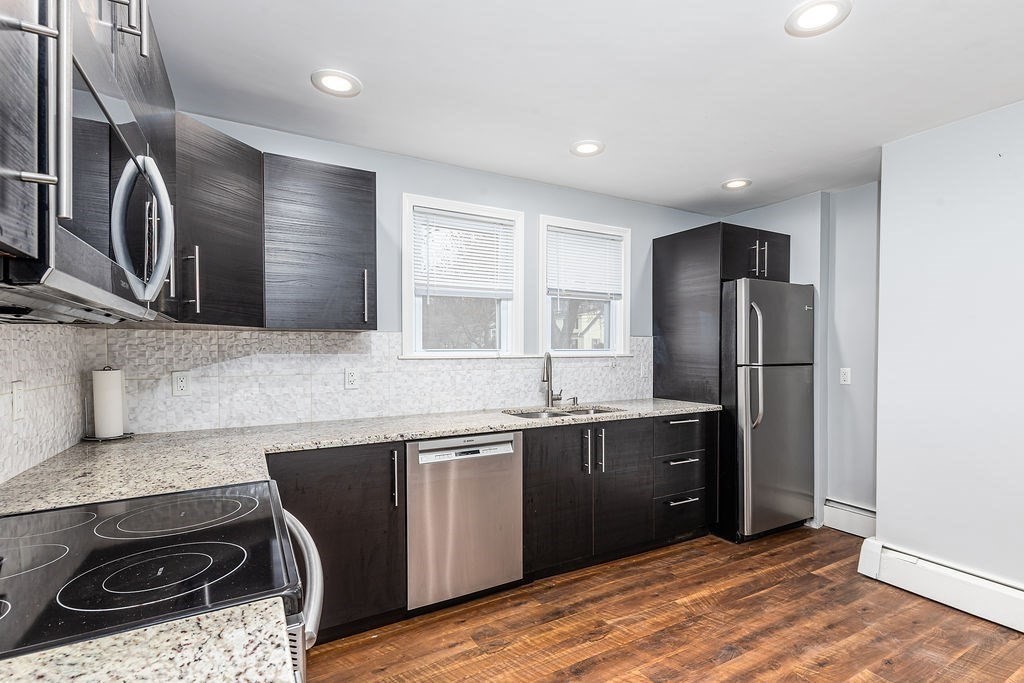 363 Concord Road Billerica, MA 01821 - Photo 11 of 42 a kitchen with stainless steel appliances granite countertop a refrigerator and a stove top oven