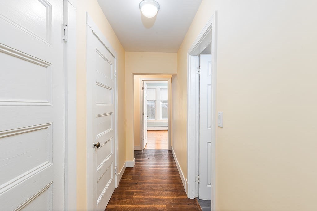 363 Concord Road Billerica, MA 01821 - Photo 12 of 42 a view of a hallway with wooden floor and a bathroom