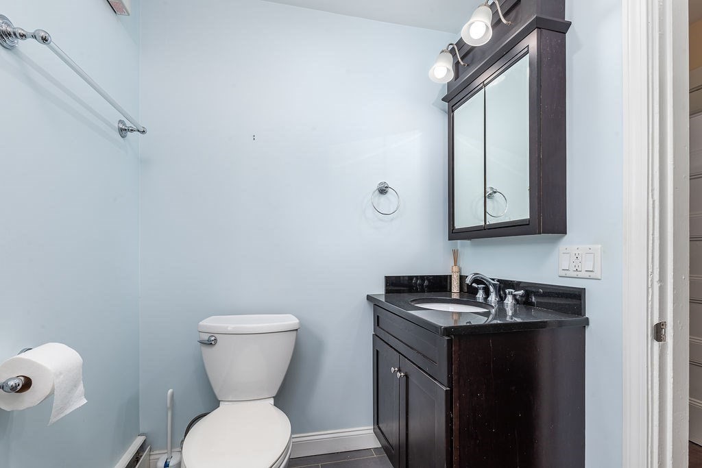 363 Concord Road Billerica, MA 01821 - Photo 13 of 42 a bathroom with a toilet sink and mirror