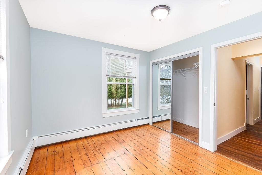 363 Concord Road Billerica, MA 01821 - Photo 14 of 42 a view of an empty room with wooden floor and a window