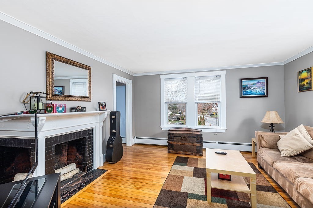 363 Concord Road Billerica, MA 01821 - Photo 23 of 42 a living room with furniture and a fireplace