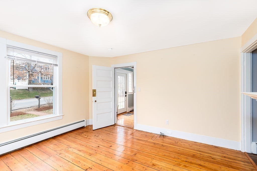 363 Concord Road Billerica, MA 01821 - Photo 7 of 42 a view of empty room with wooden floor and fan