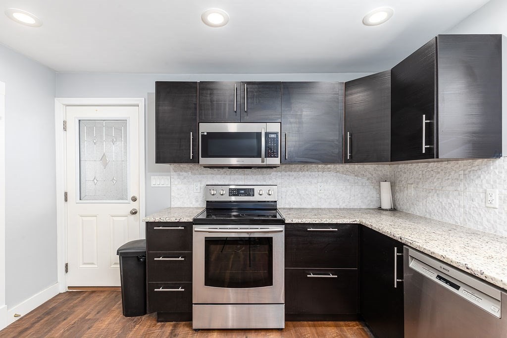 363 Concord Road Billerica, MA 01821 - Photo 10 of 42 a kitchen with a sink and a stove top oven