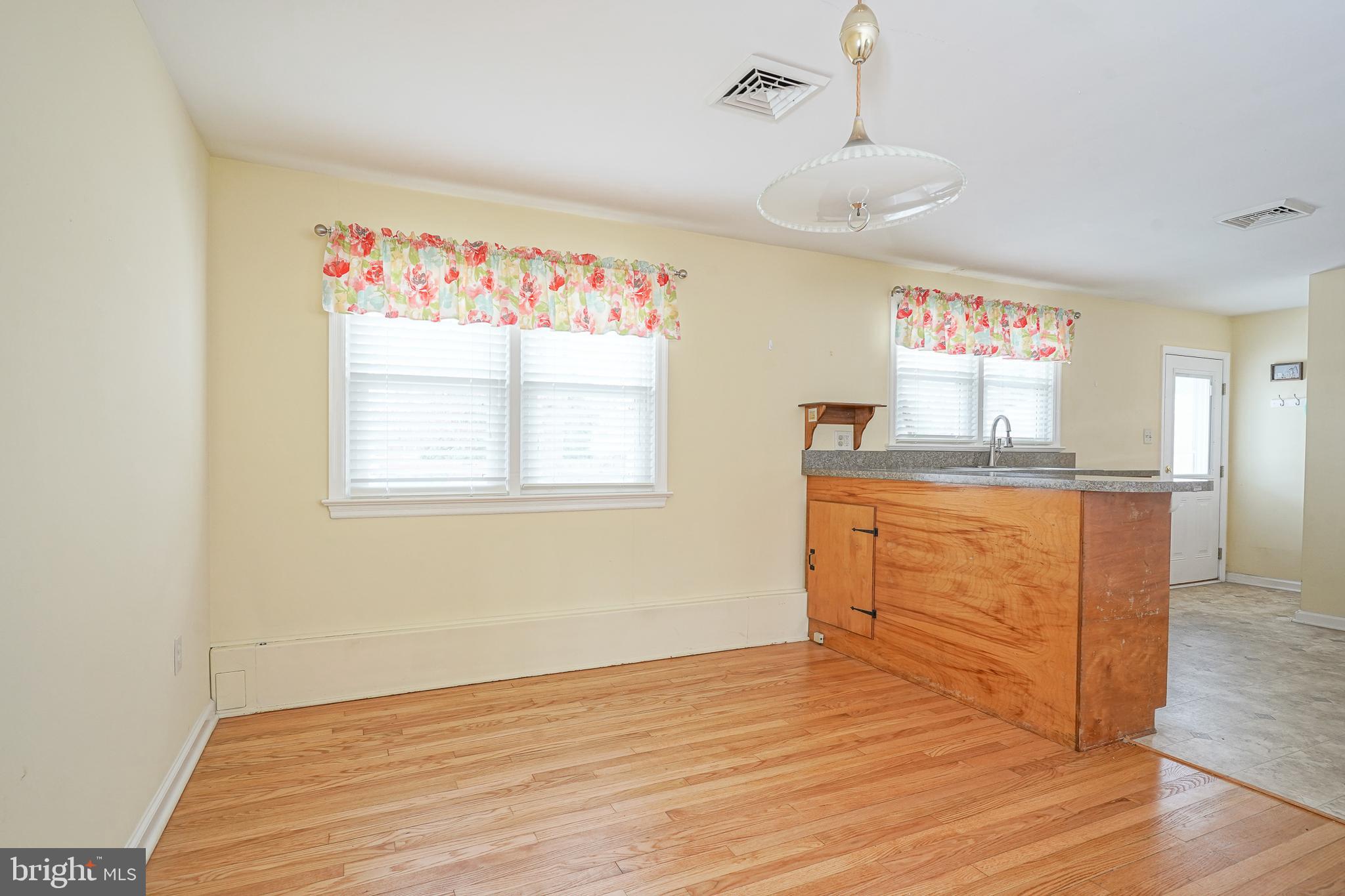 227 Harmony Road Gibbstown, NJ 08027 - Photo 12 of 29 a view of a kitchen with wooden floor and staircase