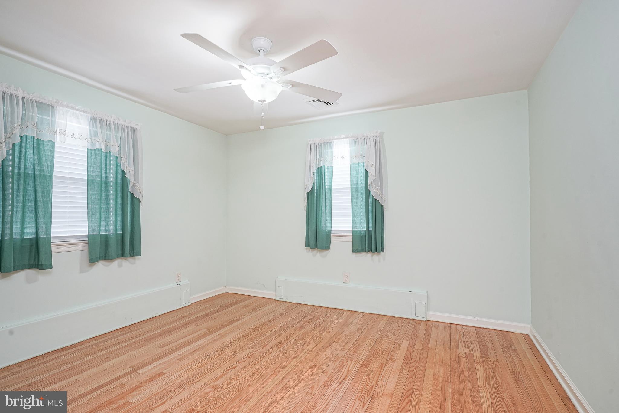 227 Harmony Road Gibbstown, NJ 08027 - Photo 13 of 29 wooden floor in an empty room with a window