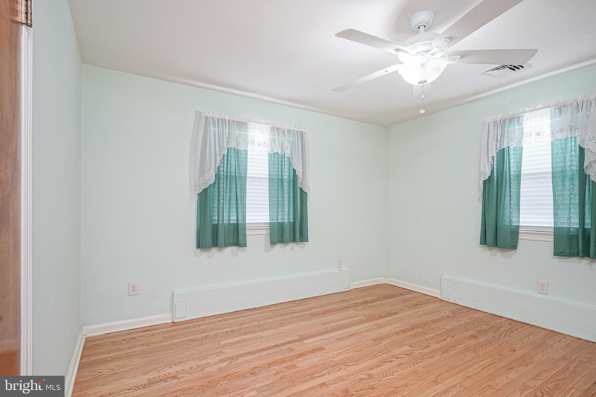 227 Harmony Road Gibbstown, NJ 08027 - Photo 14 of 29 wooden floor in an empty room with a window