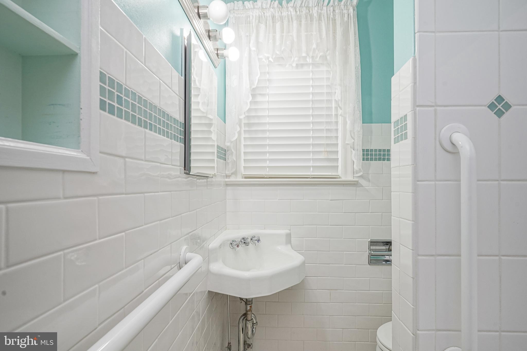227 Harmony Road Gibbstown, NJ 08027 - Photo 19 of 29 a bathroom with a sink a toilet and a mirror