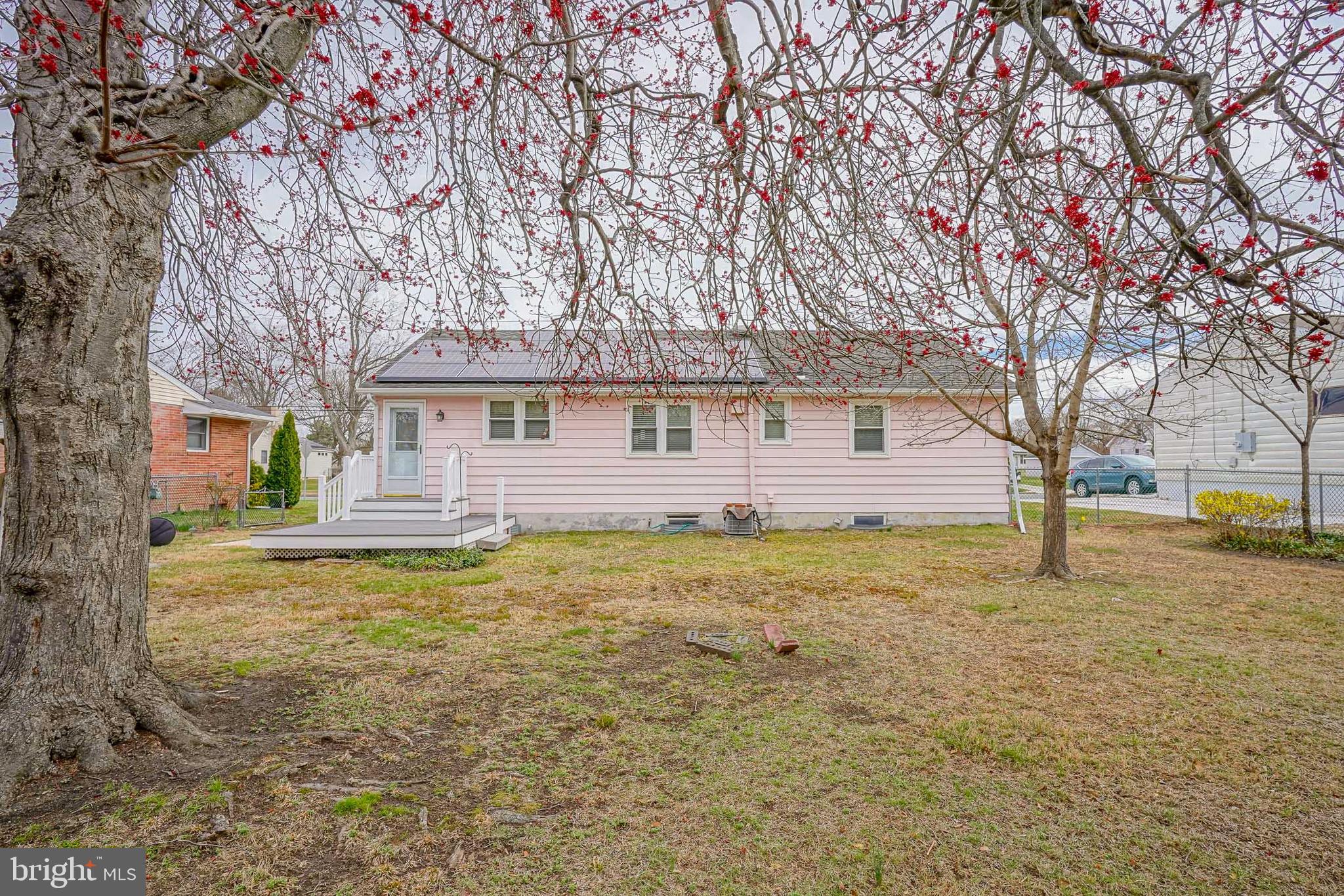 227 Harmony Road Gibbstown, NJ 08027 - Photo 29 of 29 a backyard of a house with large trees and table and chairs