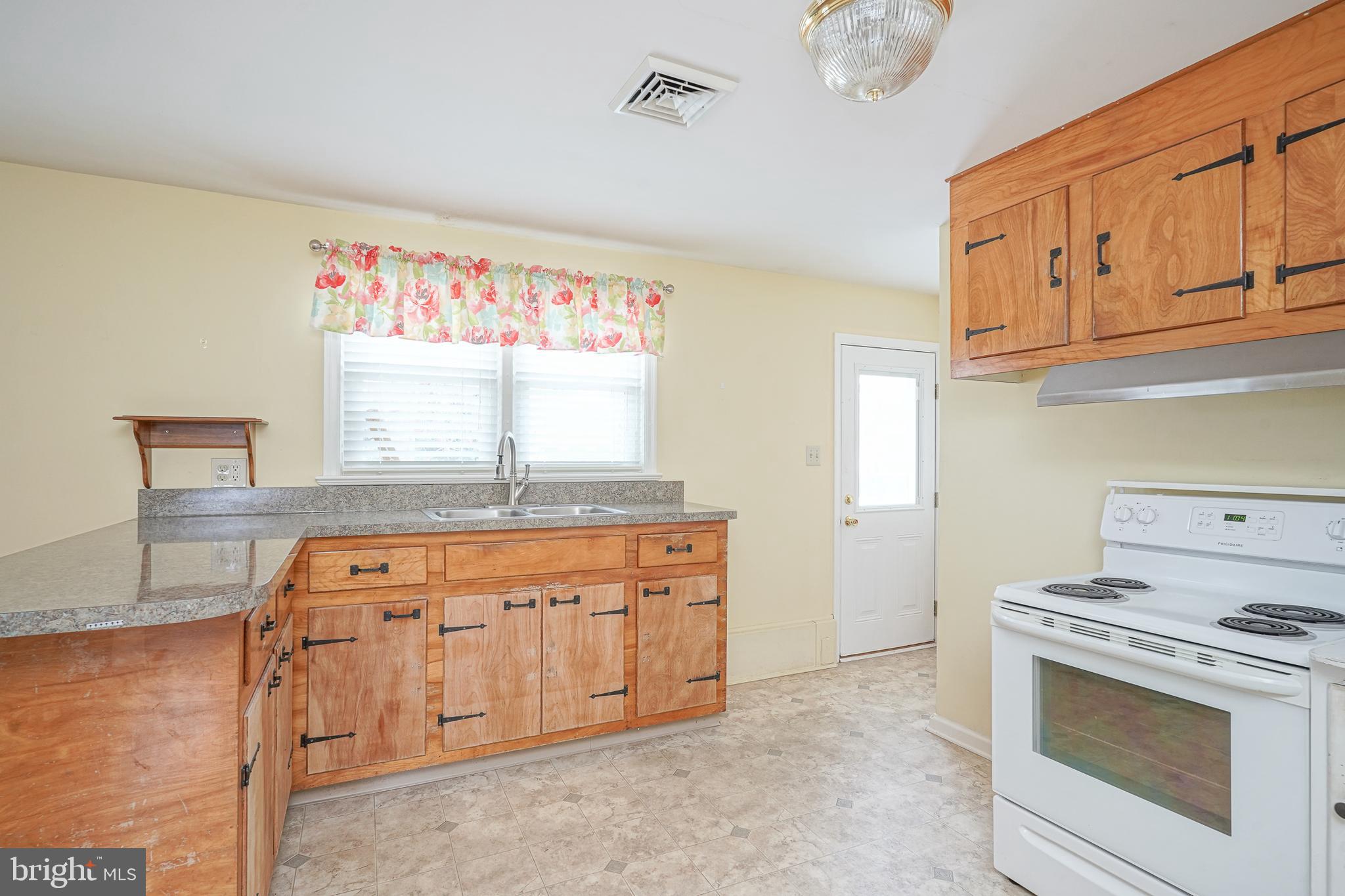 227 Harmony Road Gibbstown, NJ 08027 - Photo 7 of 29 a kitchen with granite countertop a sink stove and cabinets