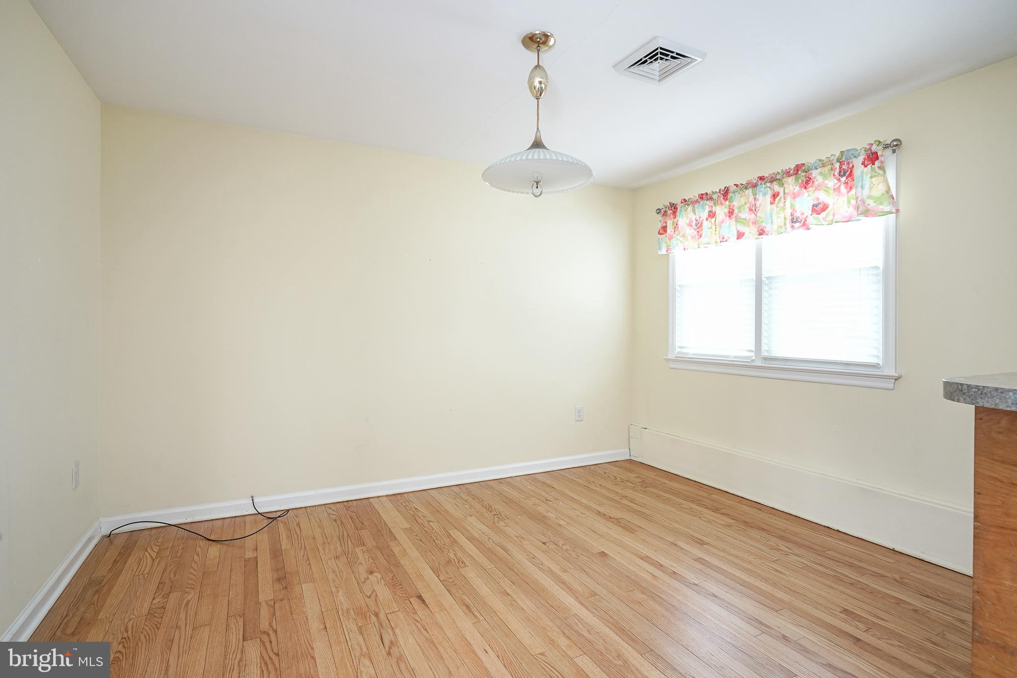 227 Harmony Road Gibbstown, NJ 08027 - Photo 10 of 29 wooden floor in an empty room with a window