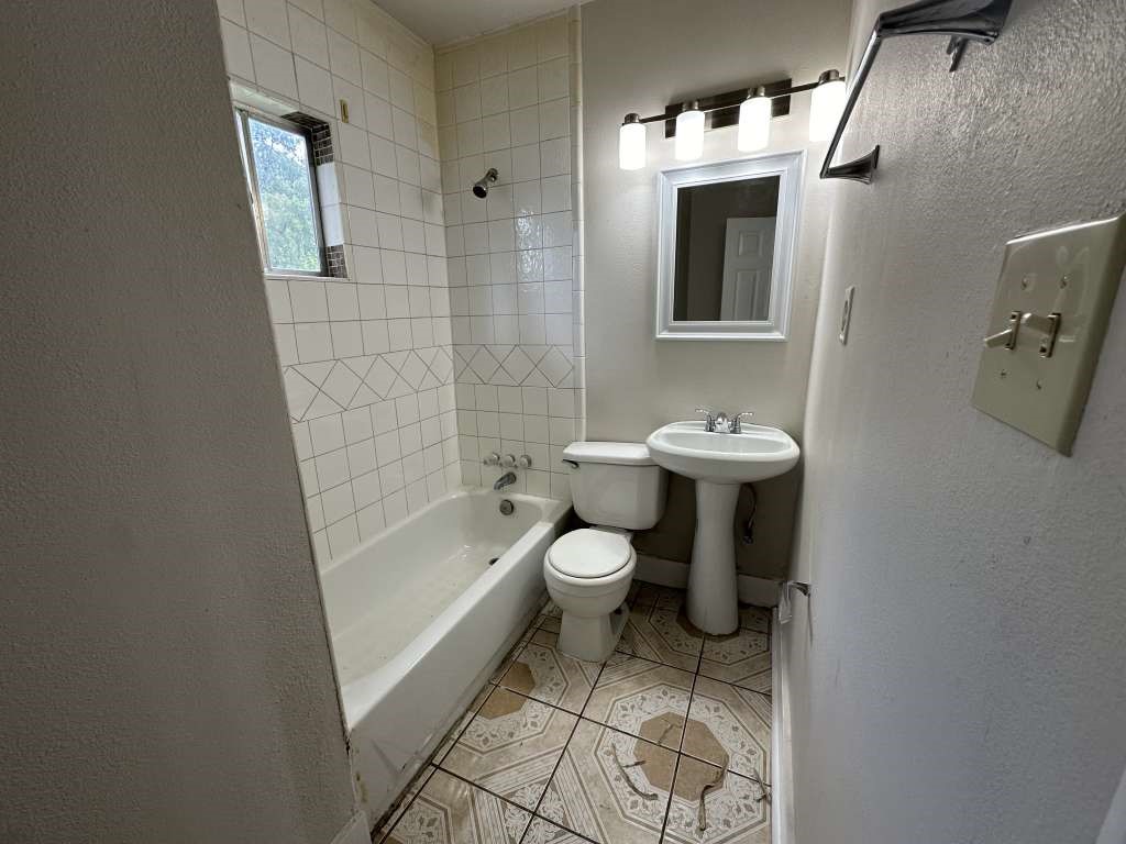 4520 Falls Street Houston, TX 77026 - Photo 10 of 11 a bathroom with a sink toilet and shower