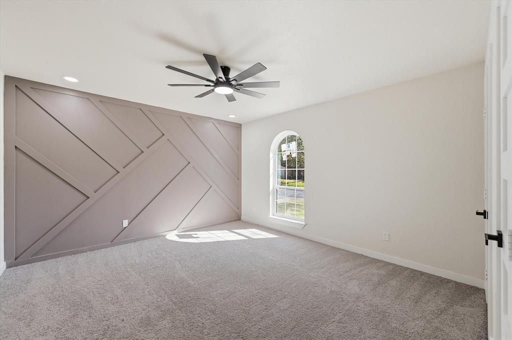 2804 Bent Tree Lane Arlington, TX 76016 - Photo 20 of 32 an empty room with windows and fan