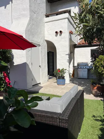 a view of house with yard and outdoor seating