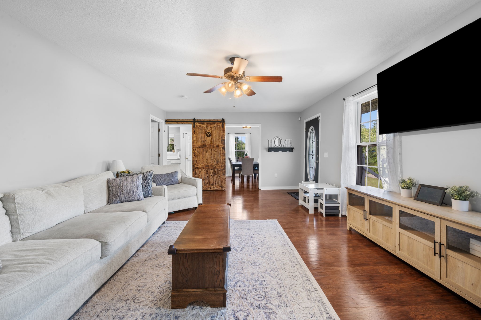 1197 Biter Road Cunningham, TN 37052 - Photo 20 of 38 a living room with furniture flat screen tv and wooden floor