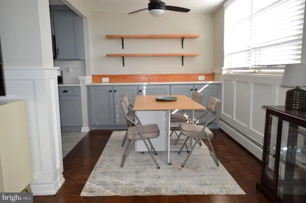 a dining room with furniture and a window