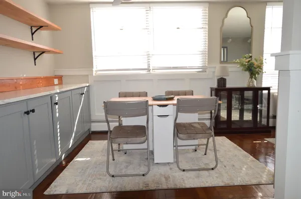 a dining room with furniture and a window