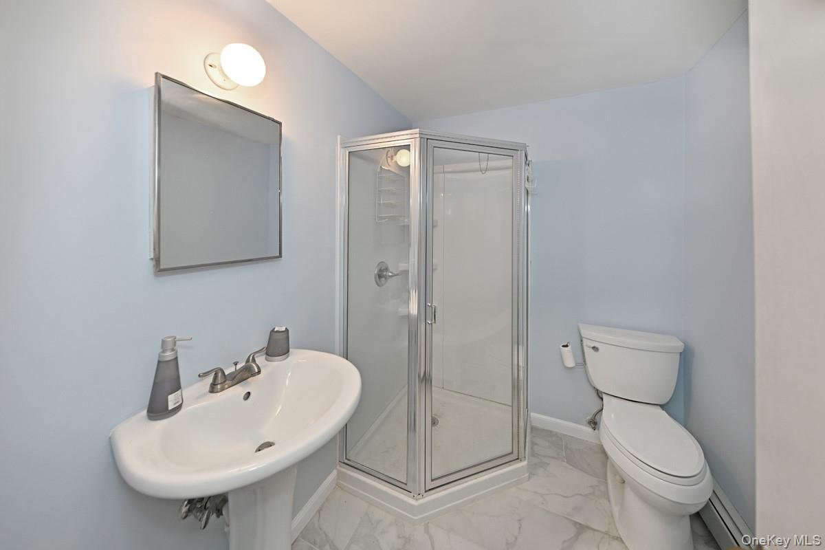 19 Sterling Road Spring Valley, NY 10977 - Photo 16 of 20 a bathroom with a toilet sink and shower