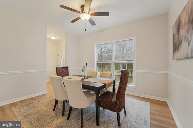 a view of a livingroom with a large window and wooden floor