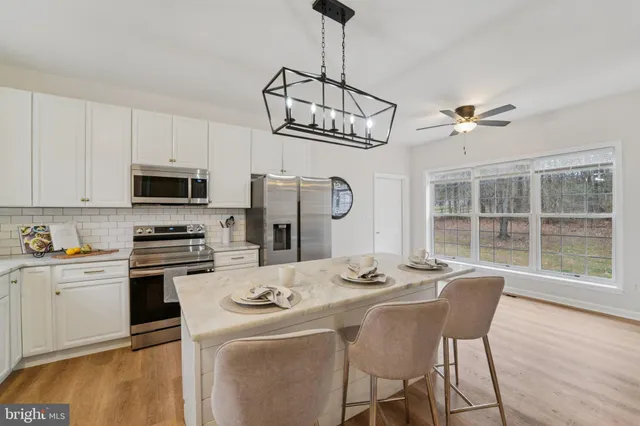 a bathroom with a sink a toilet and shower curtain