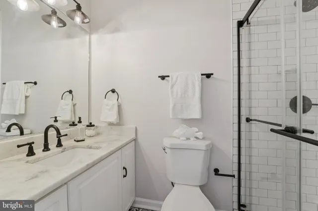 a spacious bedroom with a bed and a chandelier