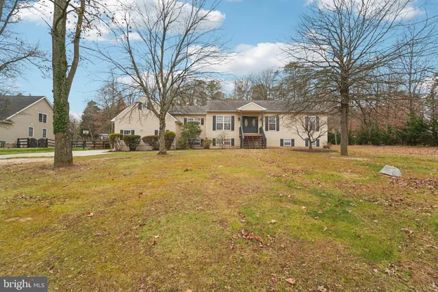 a view of a yard with a house in the background