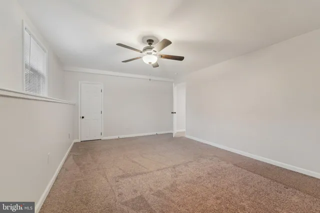 an empty room with a empty space and windows