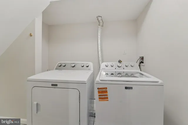 a bathroom with a toilet a sink a mirror and shower