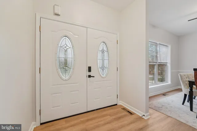a view of a bedroom with workspace and wooden floor