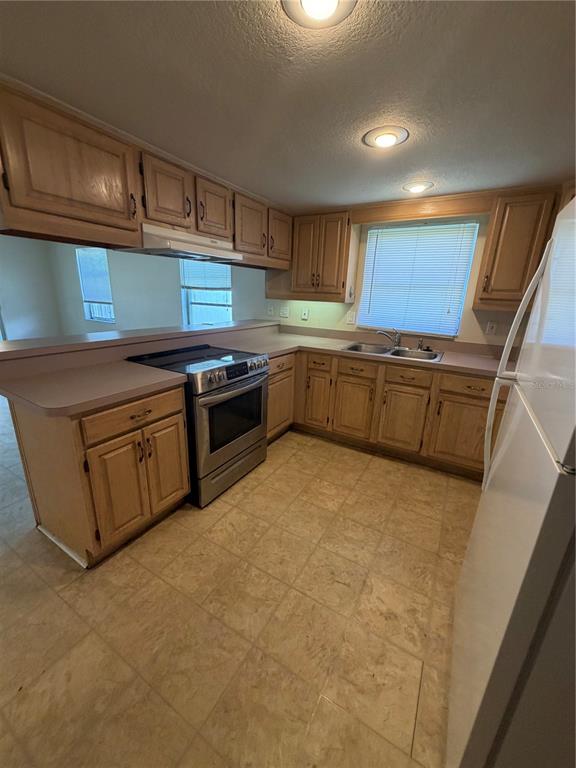 517 London Road Winter Park, FL 32792 - Photo 4 of 13 a kitchen with granite countertop a stove top oven a sink and dishwasher