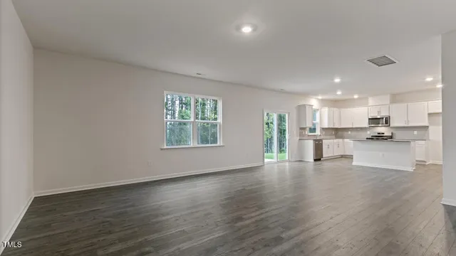 a view of kitchen with wooden floor and windows